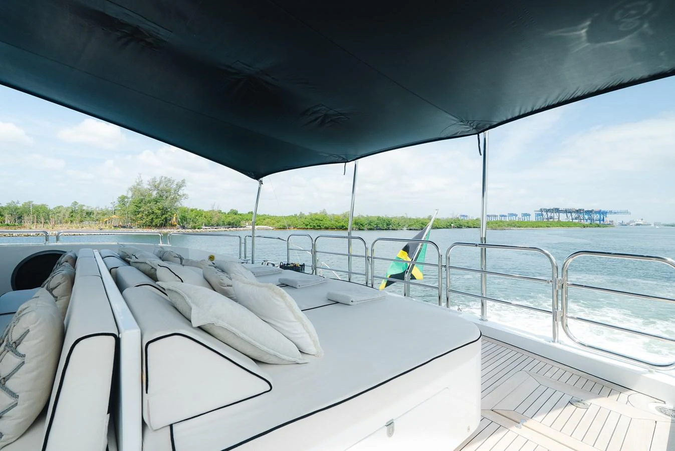 The sundeck offers a luxurious lounging area with comfortable seating and a shaded canopy, perfect for relaxation while cruising. aboard BET ON IT Yacht for Sale