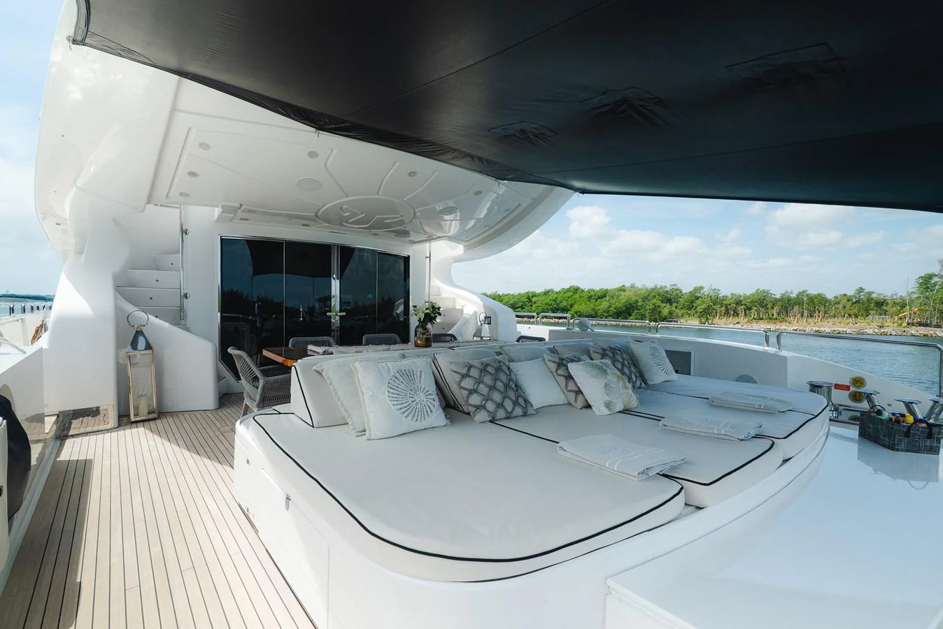 The aft deck features luxurious sun loungers and a shaded area for relaxation. aboard BET ON IT Yacht for Sale