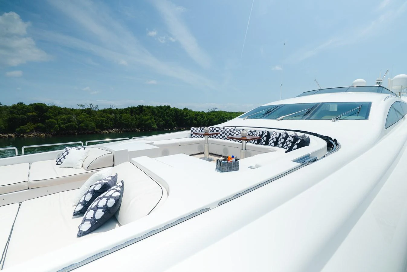 The foredeck offers a spacious lounging area with plush seating and scenic views. aboard BET ON IT Yacht for Sale