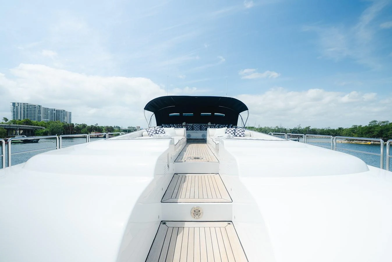 The yacht's sleek exterior features a spacious deck with a modern design, set against a serene waterfront backdrop. aboard BET ON IT Yacht for Sale