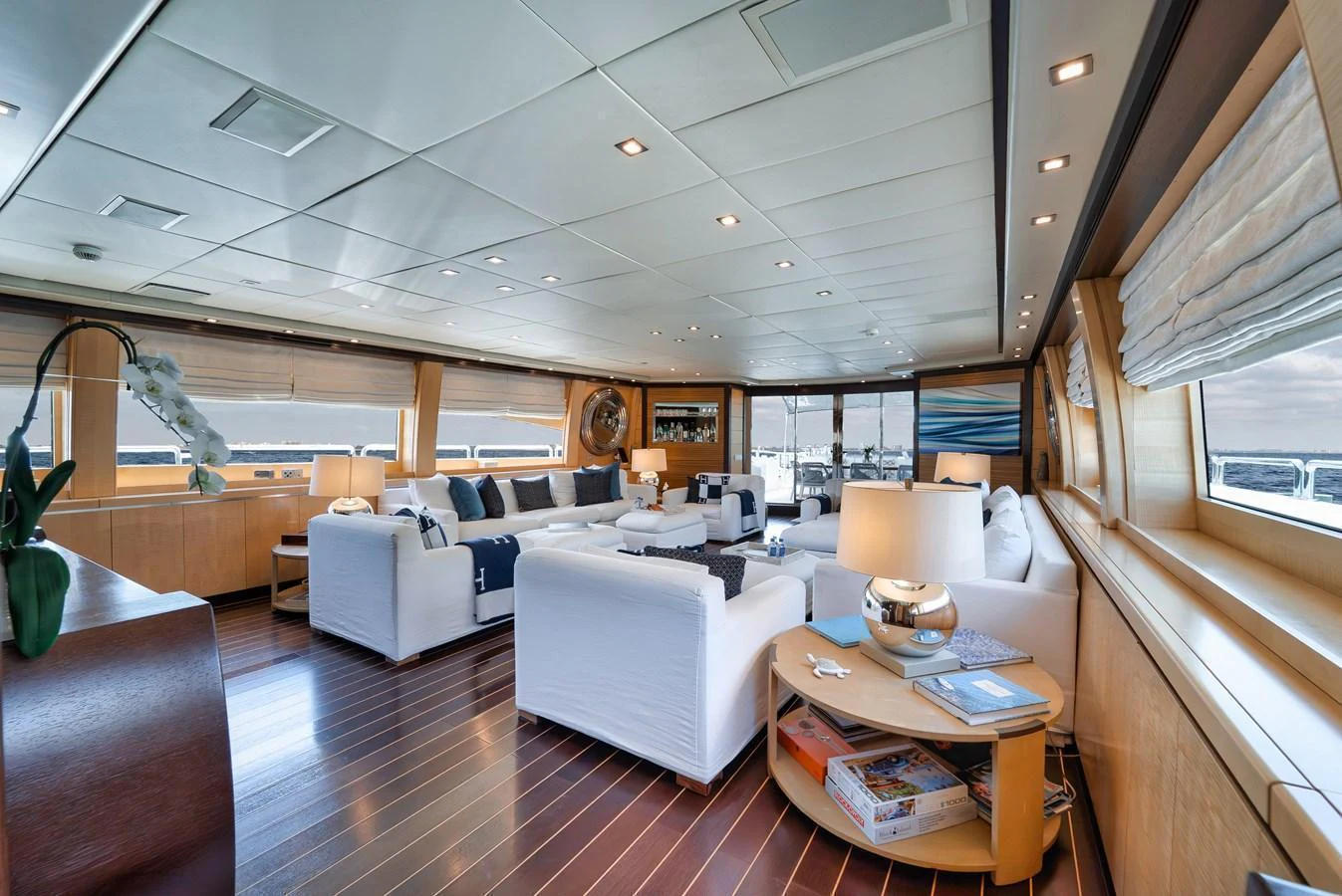 The salon offers a spacious and elegantly designed area with ample seating and natural light. aboard BET ON IT Yacht for Sale