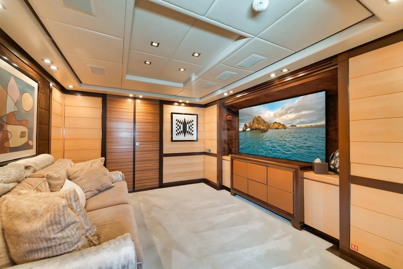 The yacht's interior features a cozy lounge area with plush seating and a large flat-screen TV. aboard BET ON IT Yacht for Sale