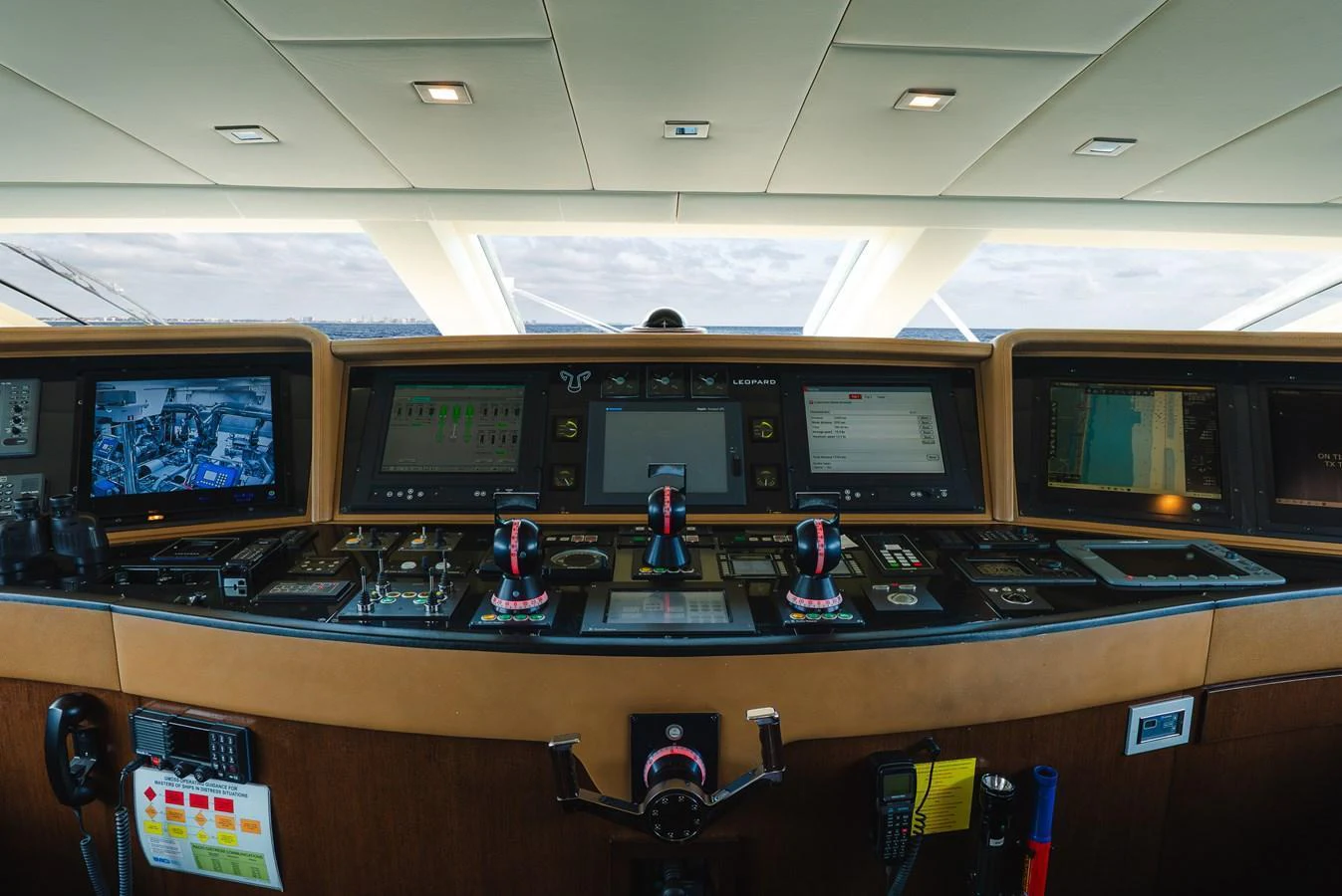 The helm station is equipped with advanced navigation and control systems, offering a commanding view for the captain. aboard BET ON IT Yacht for Sale