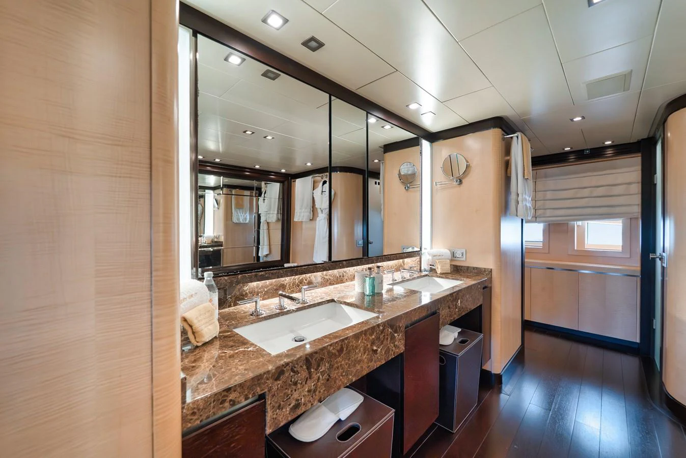 The yacht's bathroom features a luxurious double sink vanity with a marble countertop and ample storage. aboard BET ON IT Yacht for Sale