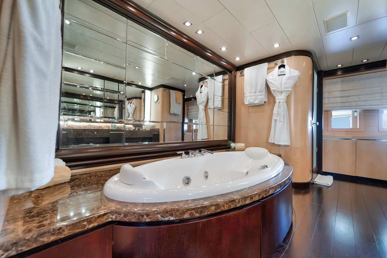 The luxurious bathroom features a large jacuzzi tub and elegant finishes. aboard BET ON IT Yacht for Sale