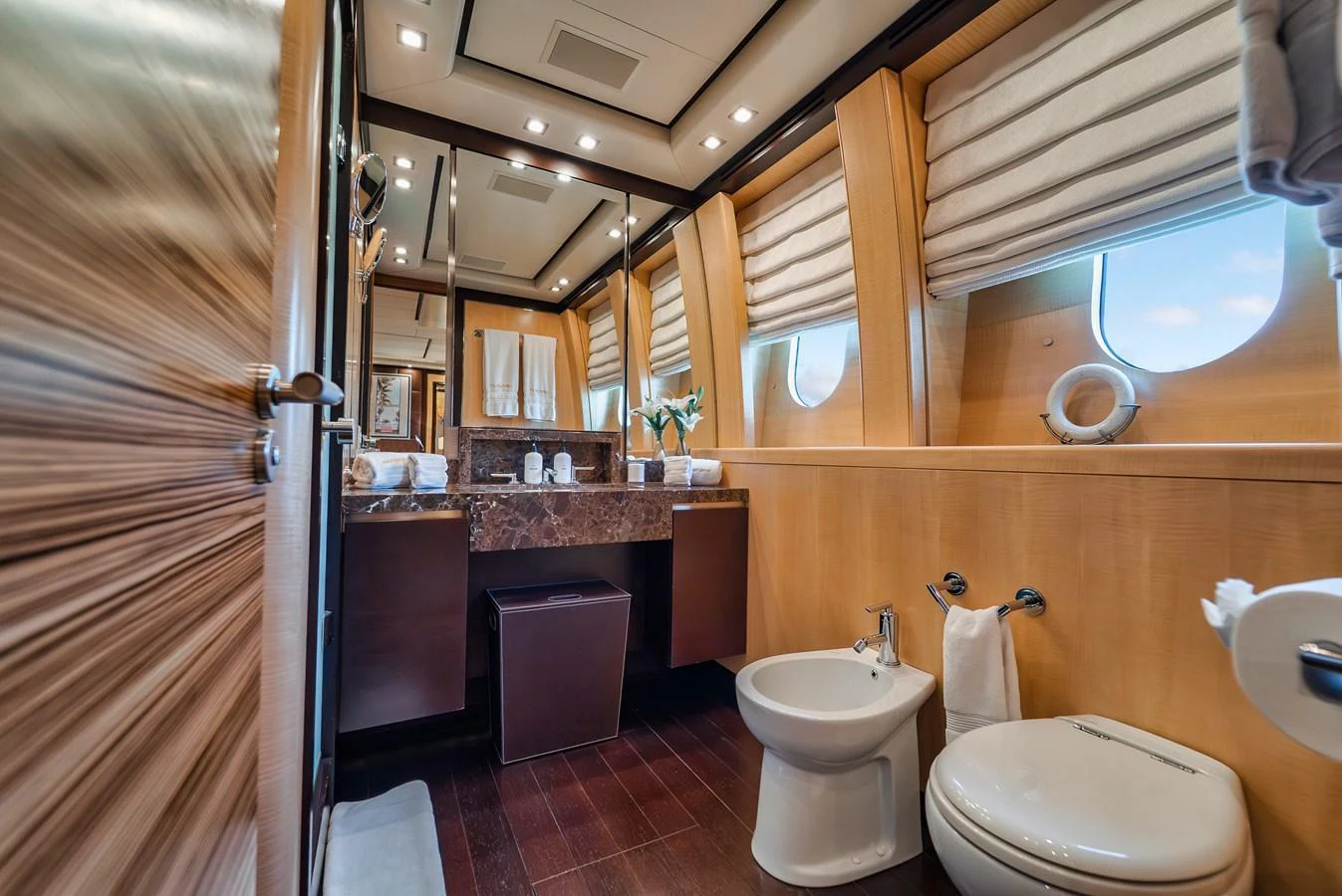 The yacht's bathroom features luxurious wood paneling and modern fixtures. aboard BET ON IT Yacht for Sale