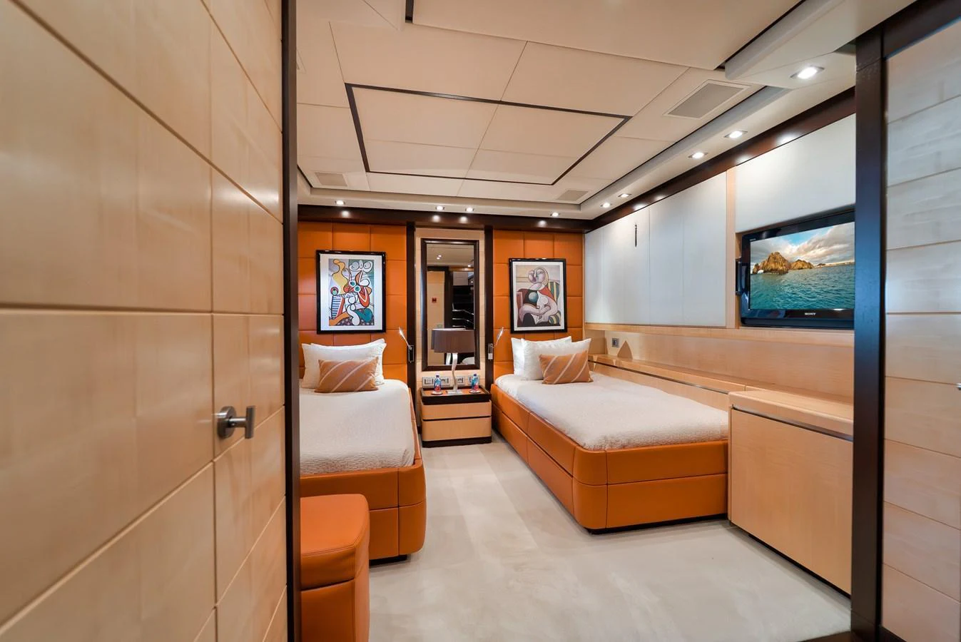 A luxurious twin stateroom featuring modern decor and comfortable bedding. aboard BET ON IT Yacht for Sale