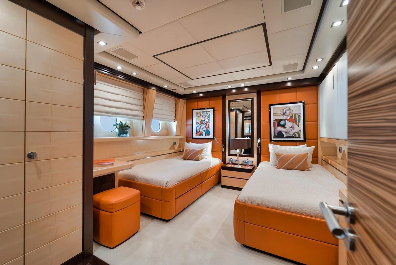 The guest stateroom features twin beds, modern decor, and ample natural light. aboard BET ON IT Yacht for Sale