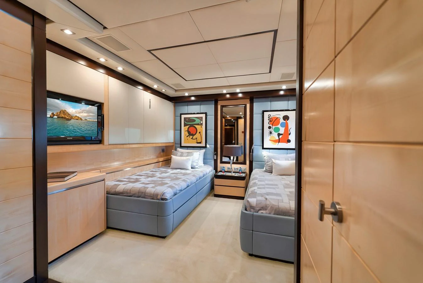 The twin stateroom offers a cozy and modern retreat with two single beds and stylish decor. aboard BET ON IT Yacht for Sale