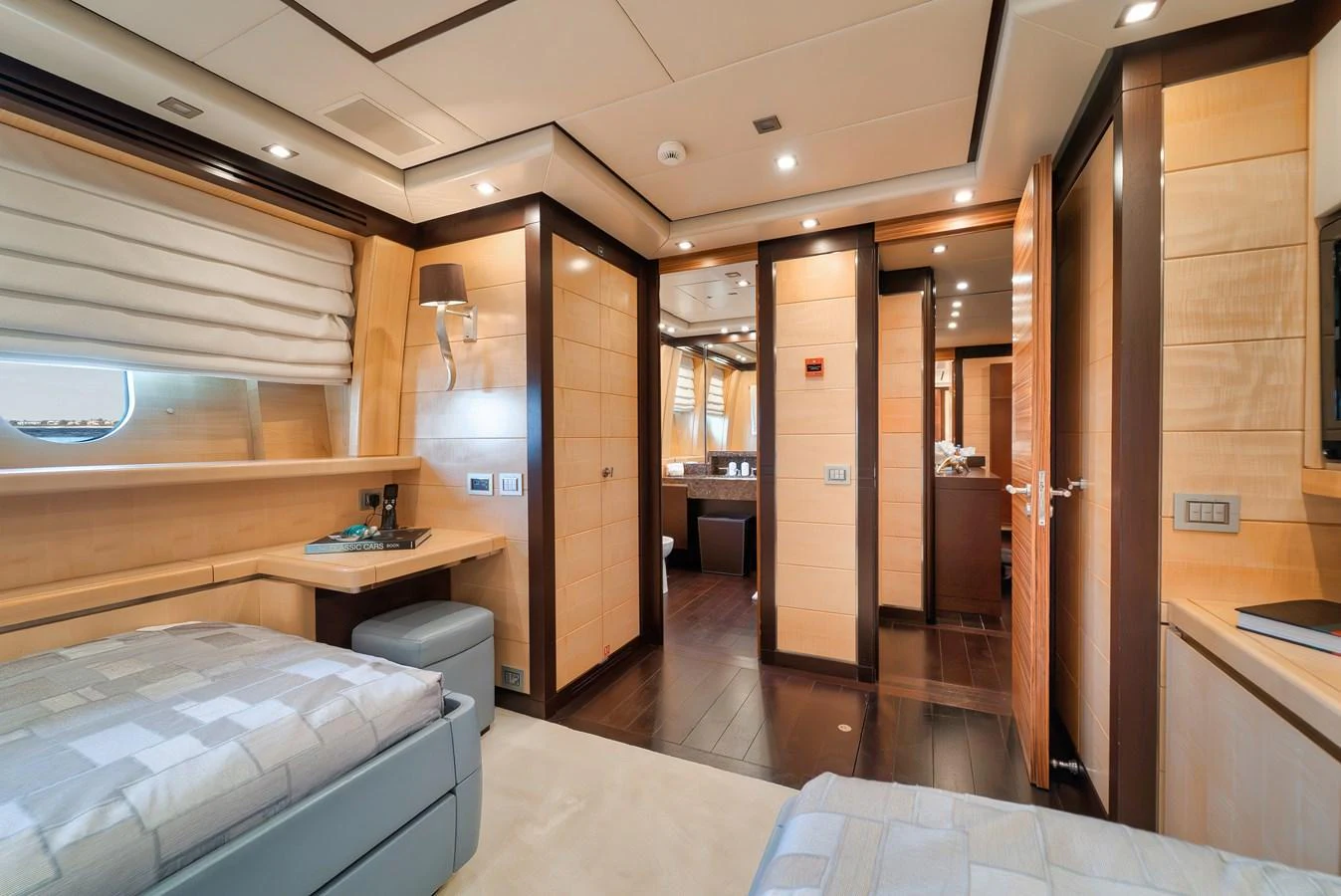 The guest stateroom features twin beds, warm wood finishes, and ample natural light. aboard BET ON IT Yacht for Sale
