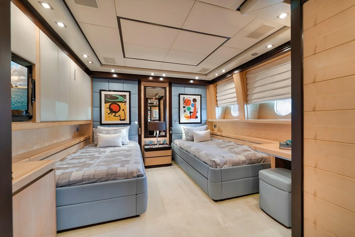The guest stateroom features twin beds, modern decor, and ample natural light. aboard BET ON IT Yacht for Sale