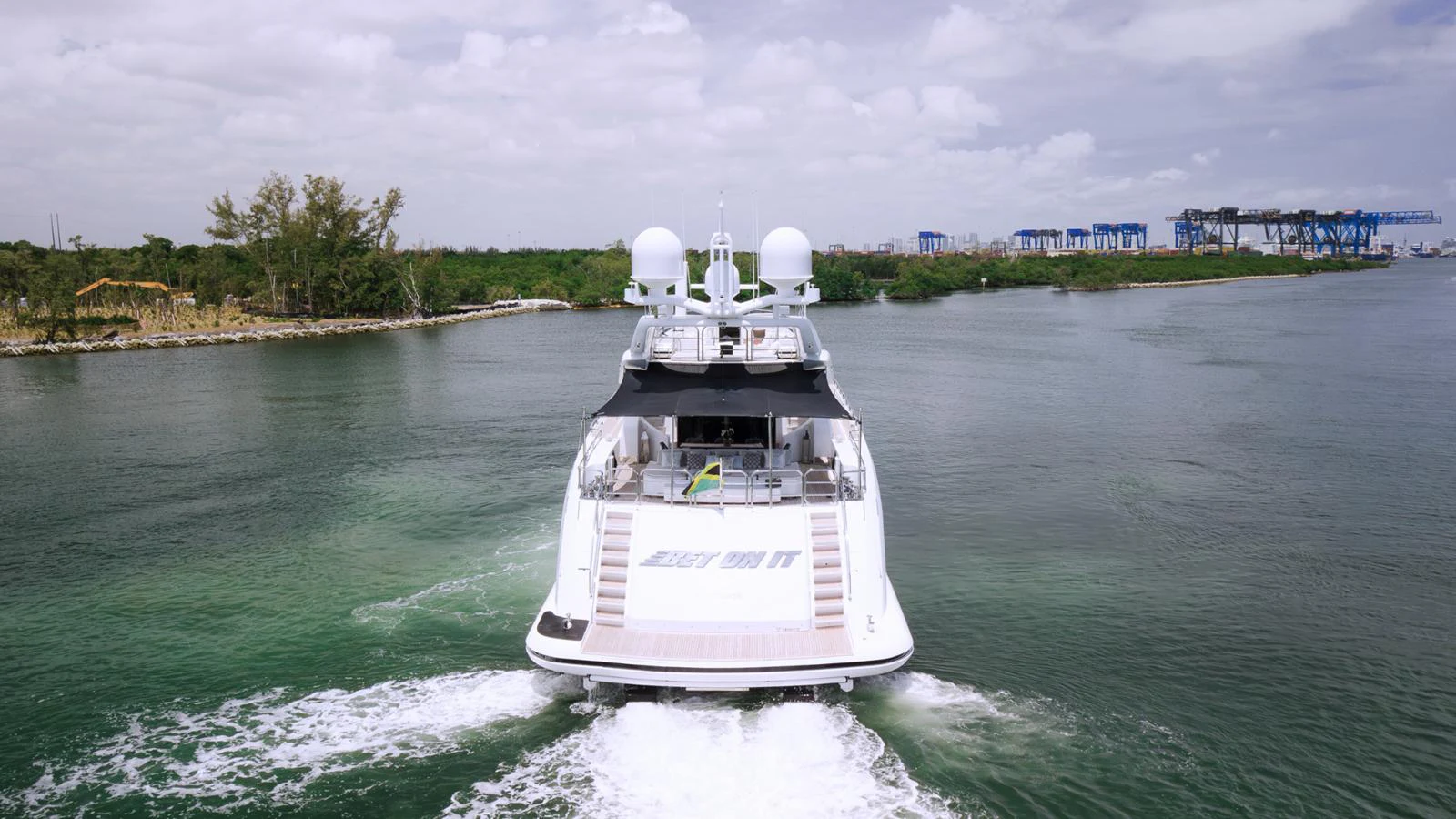 A sleek yacht cruises through calm waters, showcasing its modern design and powerful engines. aboard BET ON IT Yacht for Sale