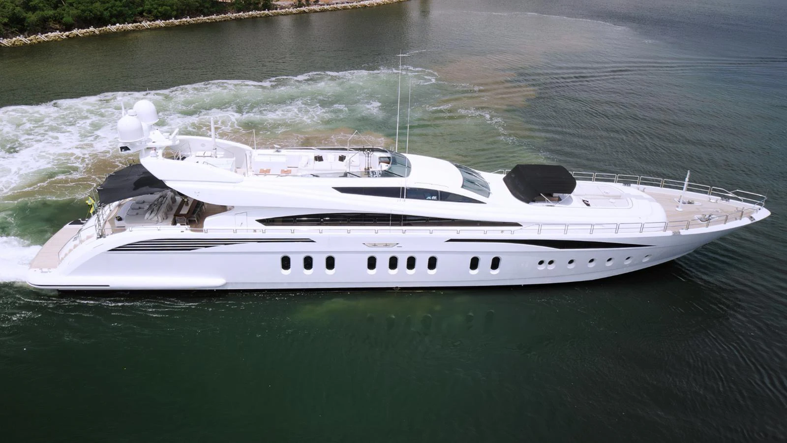 A sleek and modern yacht glides gracefully through calm waters, showcasing its elegant design and luxurious amenities. aboard BET ON IT Yacht for Sale