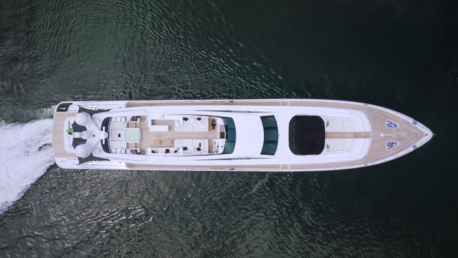 Aerial view of a sleek, modern yacht cruising through the water. aboard BET ON IT Yacht for Sale