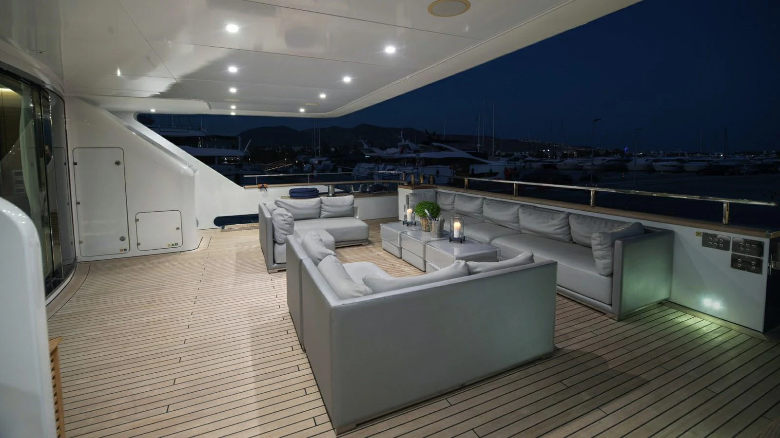 The aft deck features a spacious and elegantly lit seating area, perfect for evening relaxation. aboard IPANEMAS Yacht for Sale
