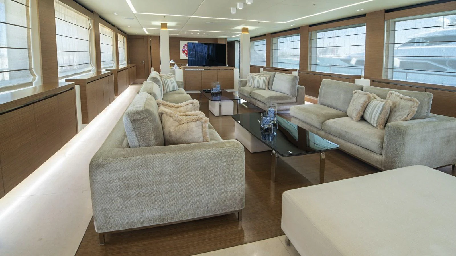 The salon features plush seating and a modern, elegant design with ample natural light. aboard IPANEMAS Yacht for Sale