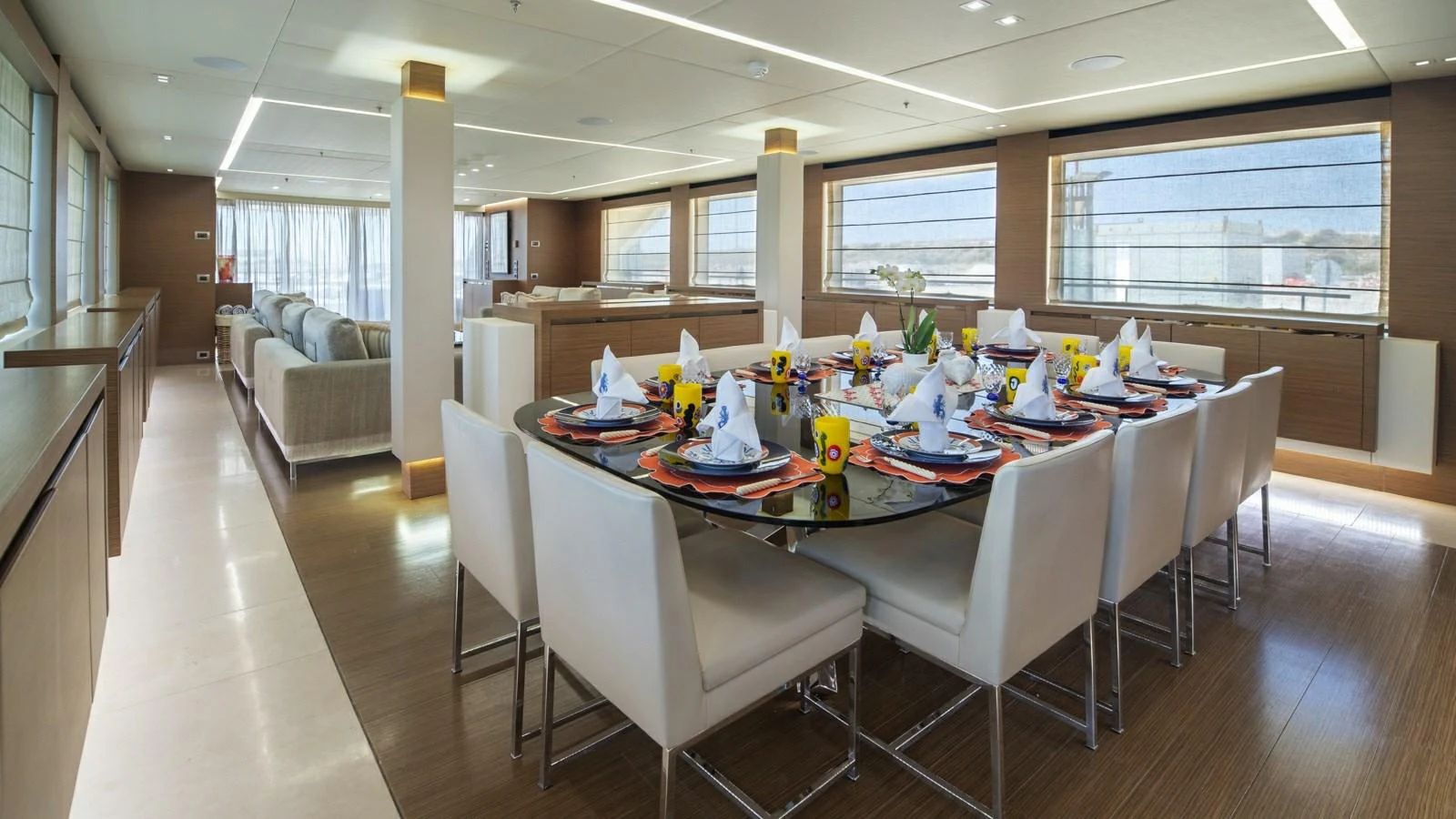 The yacht's interior dining area features a beautifully set table with elegant place settings and modern decor. aboard IPANEMAS Yacht for Sale