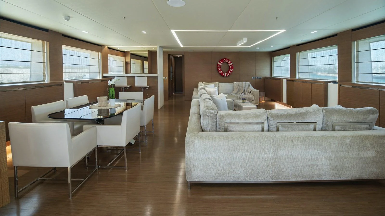 The spacious interior features a comfortable seating area and a dining table, perfect for relaxation and socializing. aboard IPANEMAS Yacht for Sale