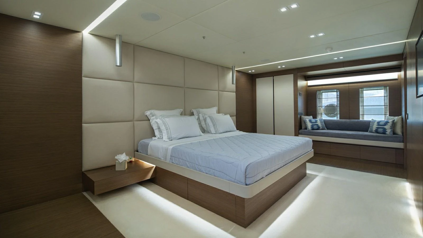 The master stateroom features a luxurious bed with modern design elements and ample natural light. aboard IPANEMAS Yacht for Sale