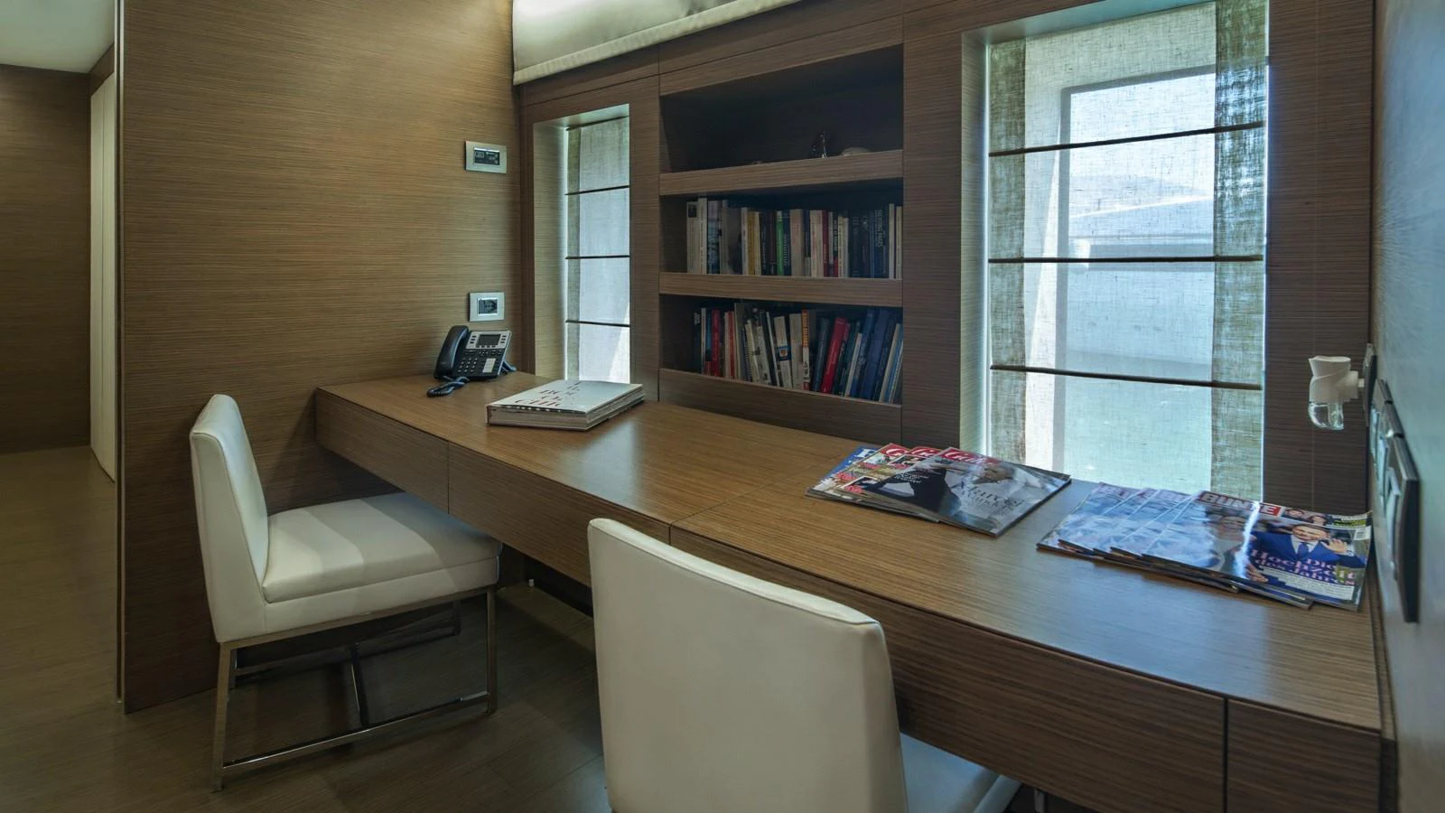 The yacht features a sophisticated office space with ample natural light and modern furnishings. aboard IPANEMAS Yacht for Sale