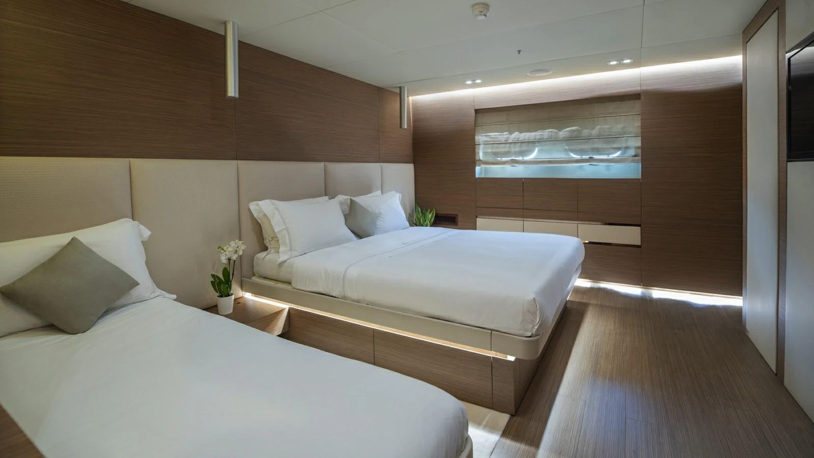 The guest stateroom features elegant bedding and modern furnishings, creating a serene and inviting atmosphere. aboard IPANEMAS Yacht for Sale