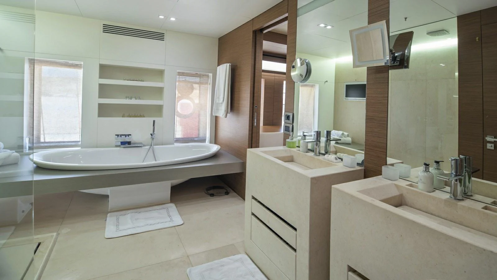 The yacht's bathroom features a modern design with a spacious bathtub and dual sinks. aboard IPANEMAS Yacht for Sale