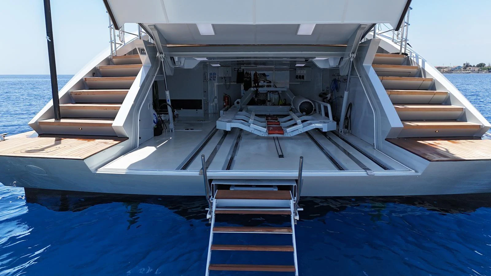 The yacht features an expansive beach club with easy access to the water and ample space for relaxation. aboard FIVE Yacht for Sale