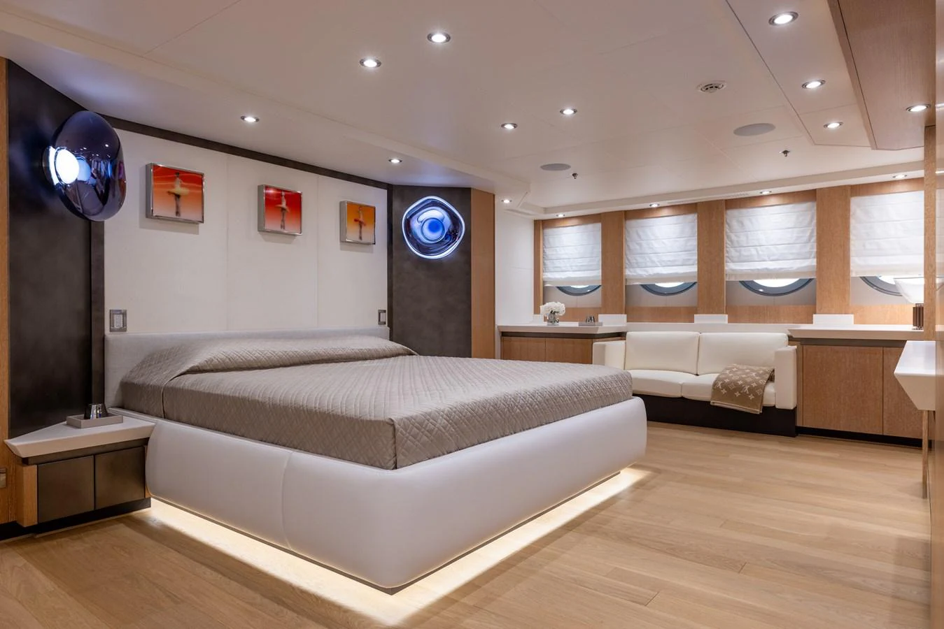 The master stateroom features a spacious bed, modern decor, and ample natural light. aboard FIVE Yacht for Sale