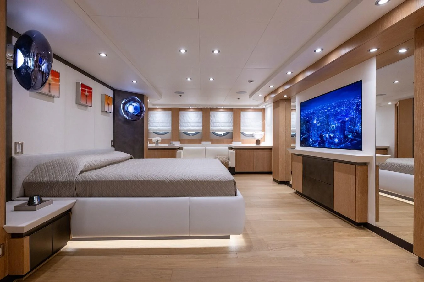 The master stateroom features a spacious layout with modern decor and ambient lighting. aboard FIVE Yacht for Sale