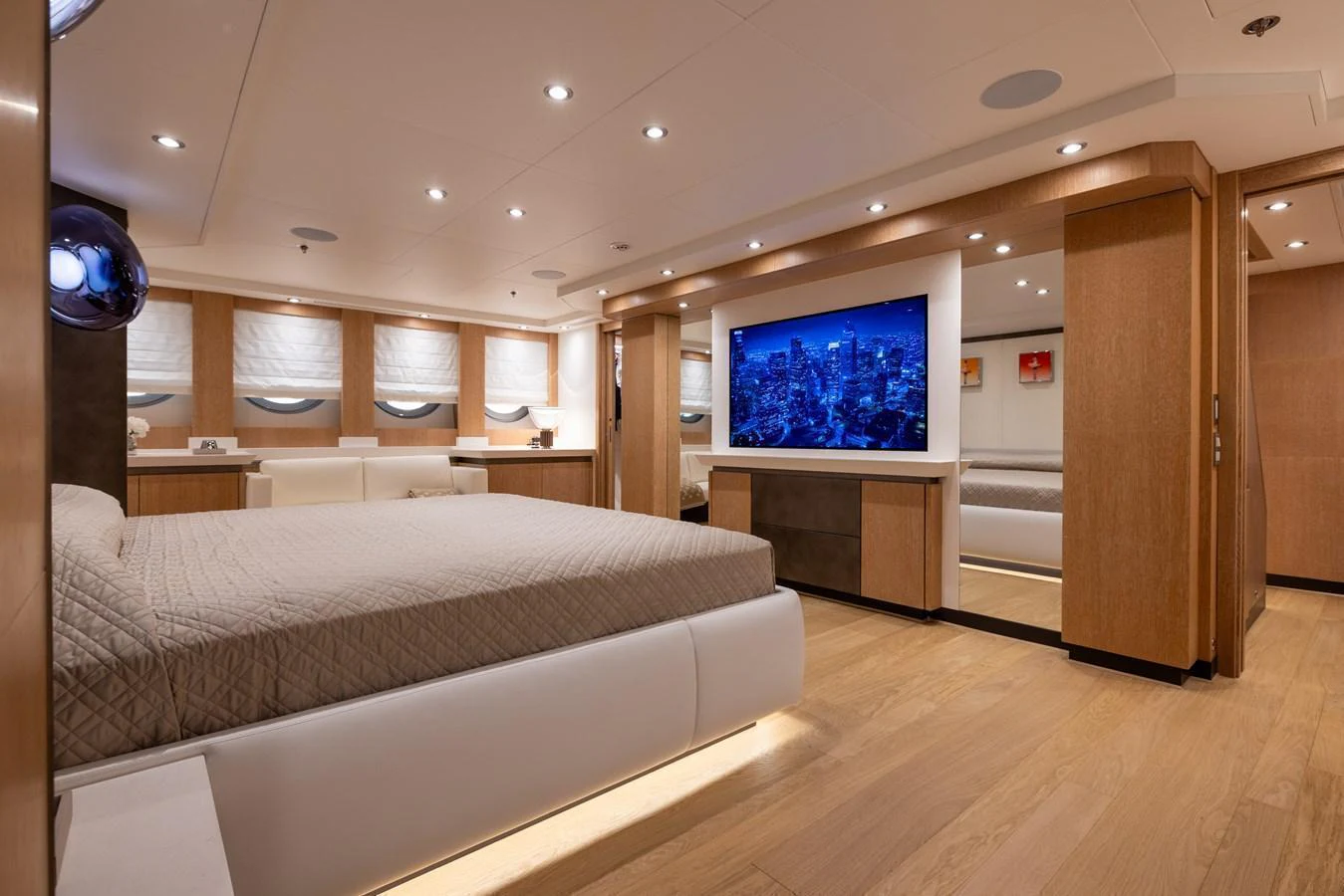 The master stateroom features a spacious layout with modern furnishings and a large flat-screen TV. aboard FIVE Yacht for Sale