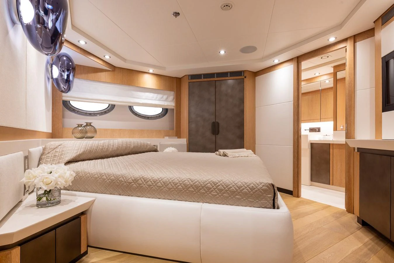 The stateroom features a luxurious bed, elegant decor, and ample natural light. aboard FIVE Yacht for Sale