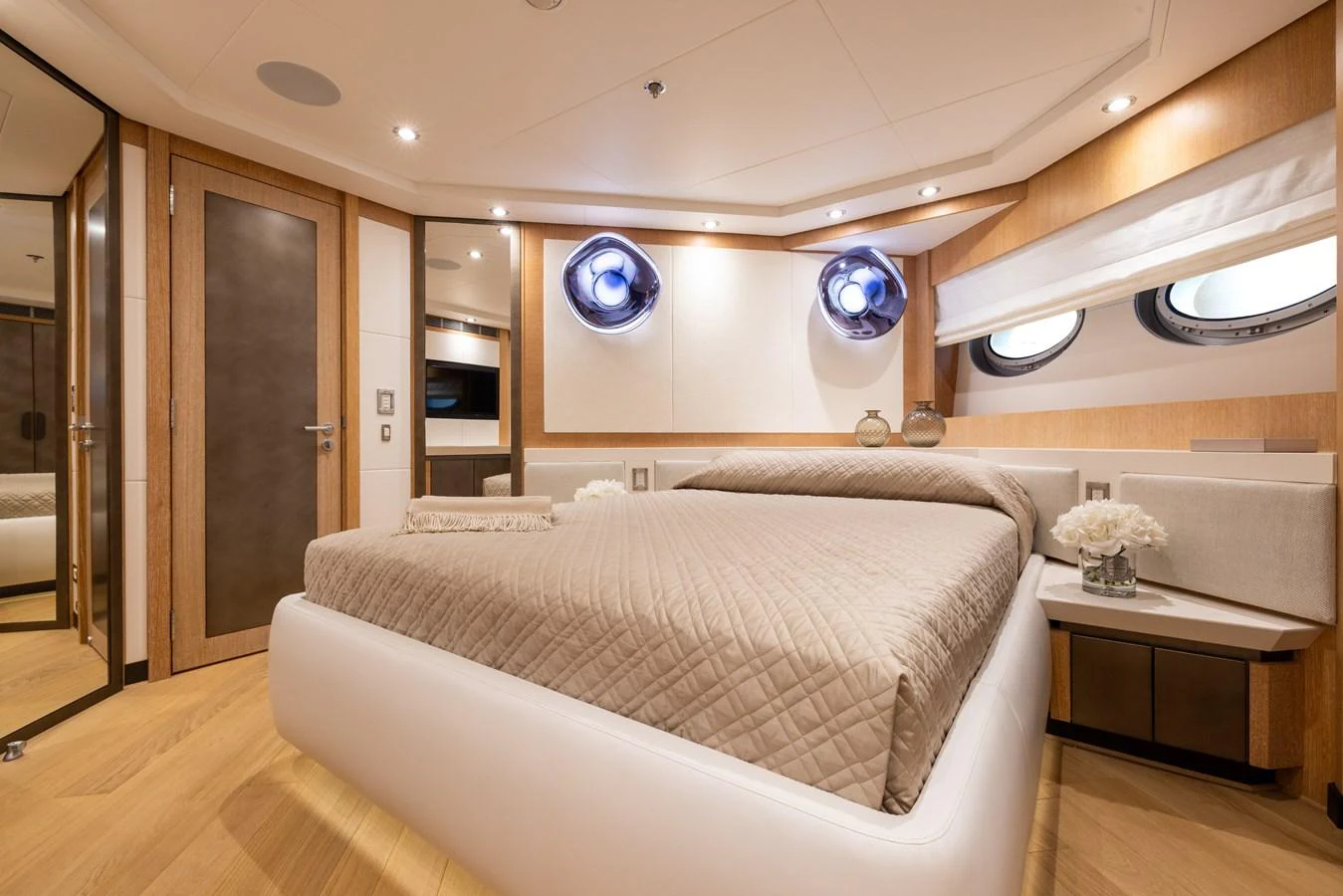 The stateroom features a luxurious bed with elegant decor and ample natural light. aboard FIVE Yacht for Sale