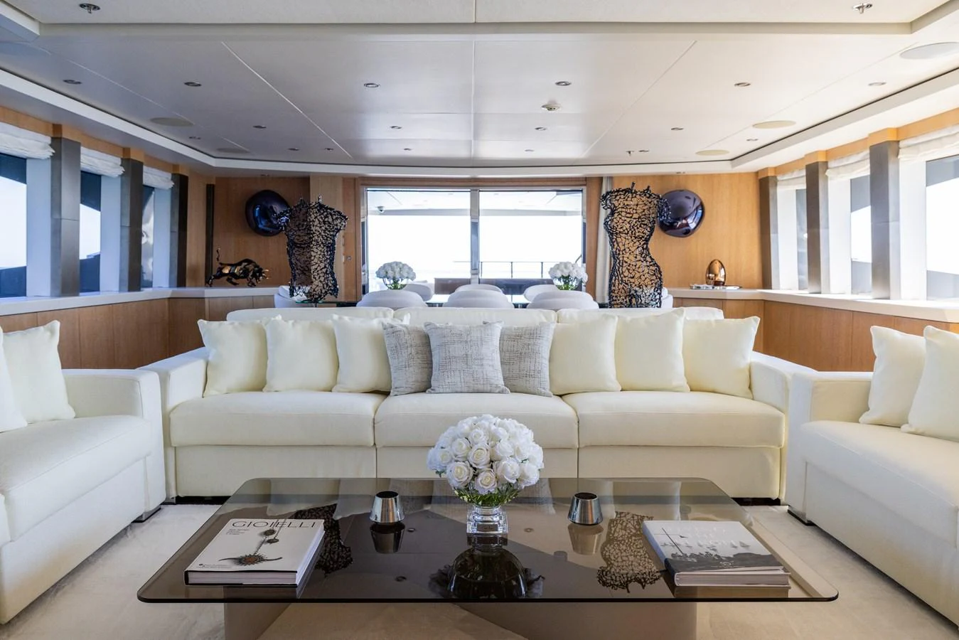 The salon features plush seating, elegant decor, and ample natural light for a luxurious and comfortable atmosphere. aboard FIVE Yacht for Sale