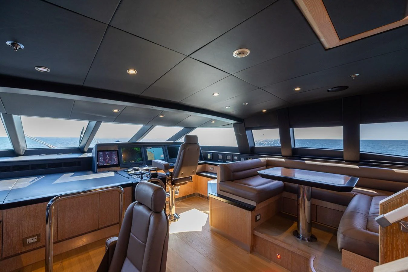 The helm area features state-of-the-art navigation equipment and luxurious seating with panoramic ocean views. aboard FIVE Yacht for Sale