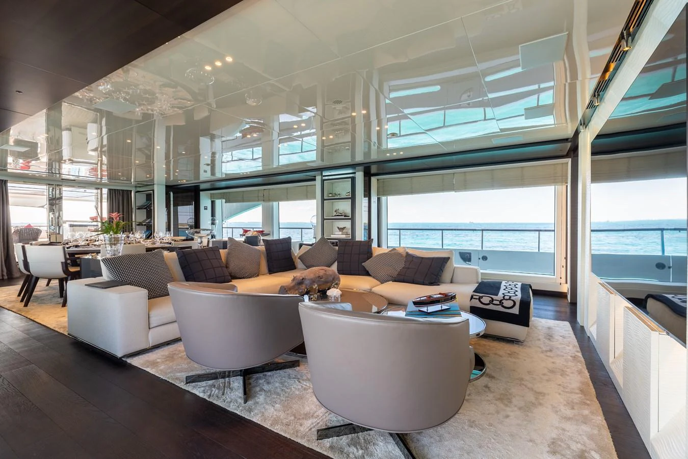 The spacious salon offers luxurious seating with panoramic views of the sea. aboard DOMANI Yacht for Sale