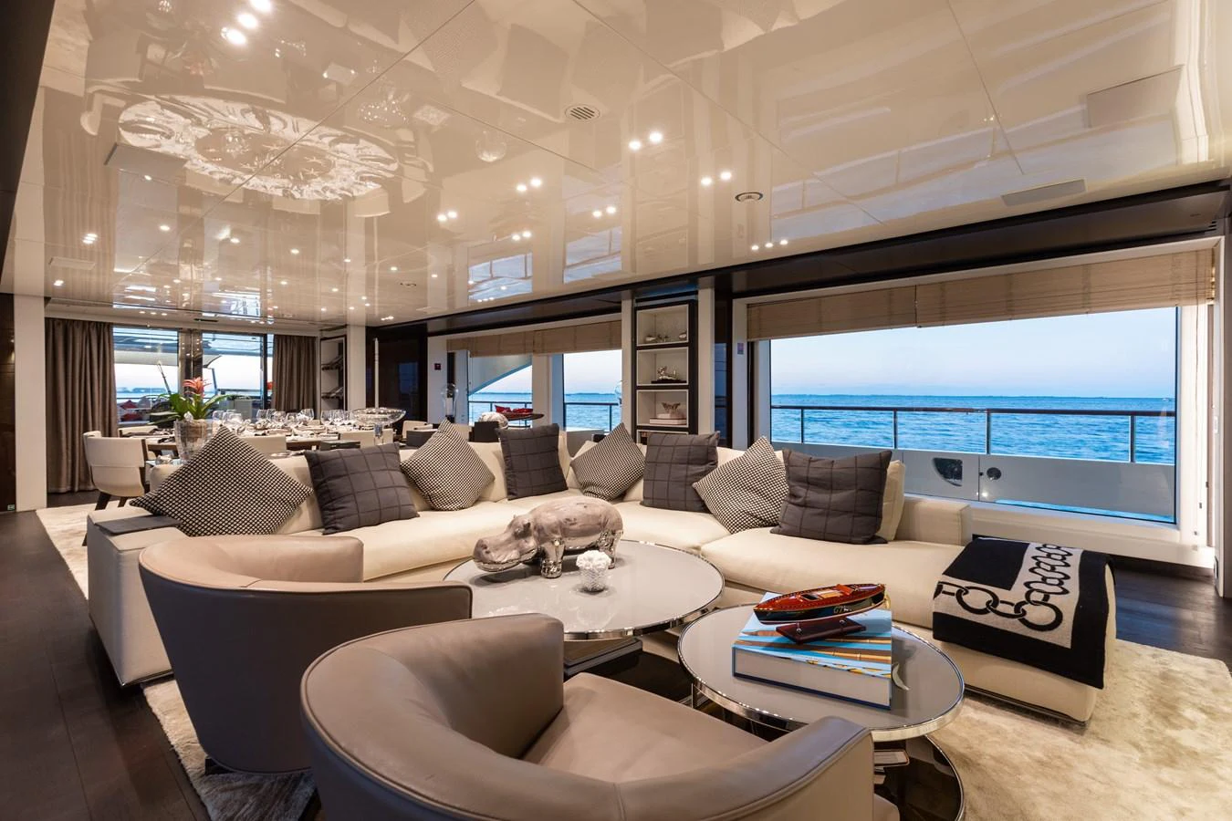 The salon offers a luxurious and spacious seating area with panoramic ocean views. aboard DOMANI Yacht for Sale