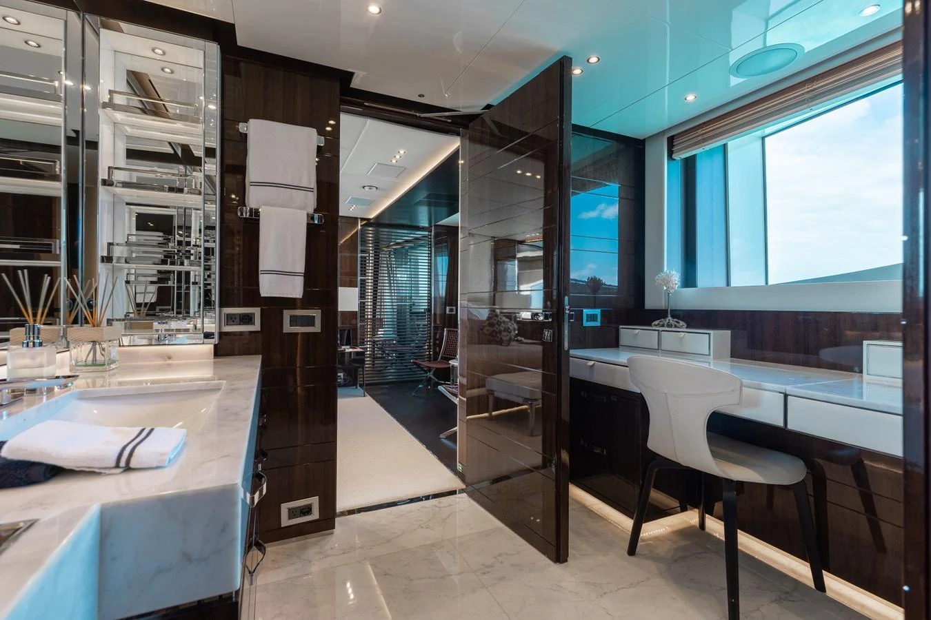 The yacht's bathroom features luxurious finishes and ample natural light. aboard DOMANI Yacht for Sale