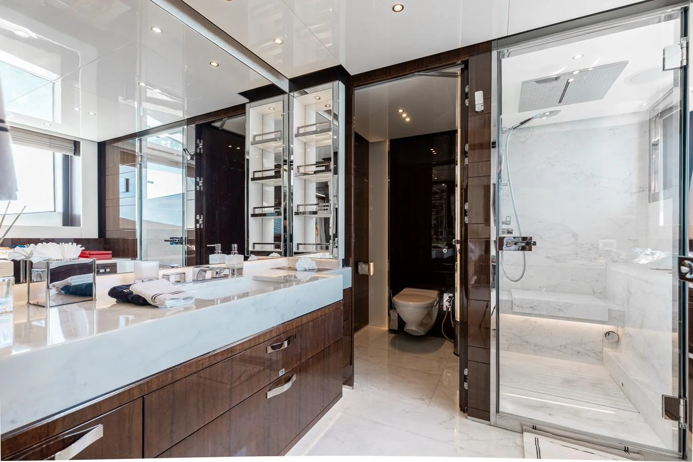 The yacht's bathroom features luxurious marble finishes and modern fixtures. aboard DOMANI Yacht for Sale