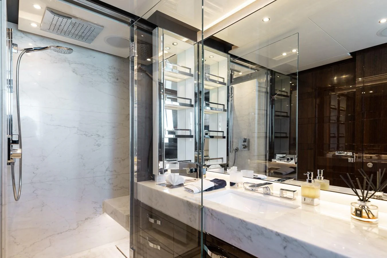 The yacht's bathroom features luxurious marble finishes and modern fixtures. aboard DOMANI Yacht for Sale