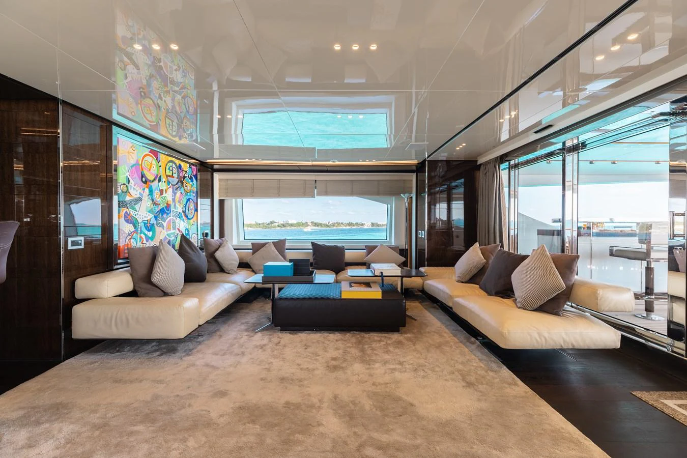 The spacious salon features luxurious seating and modern decor with large windows offering stunning views. aboard DOMANI Yacht for Sale