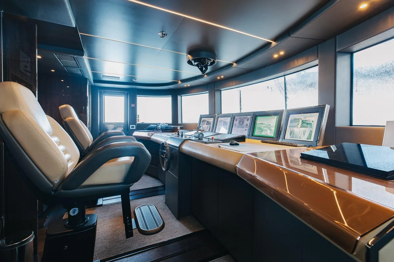 The helm station features advanced navigation equipment and luxurious seating. aboard DOMANI Yacht for Sale