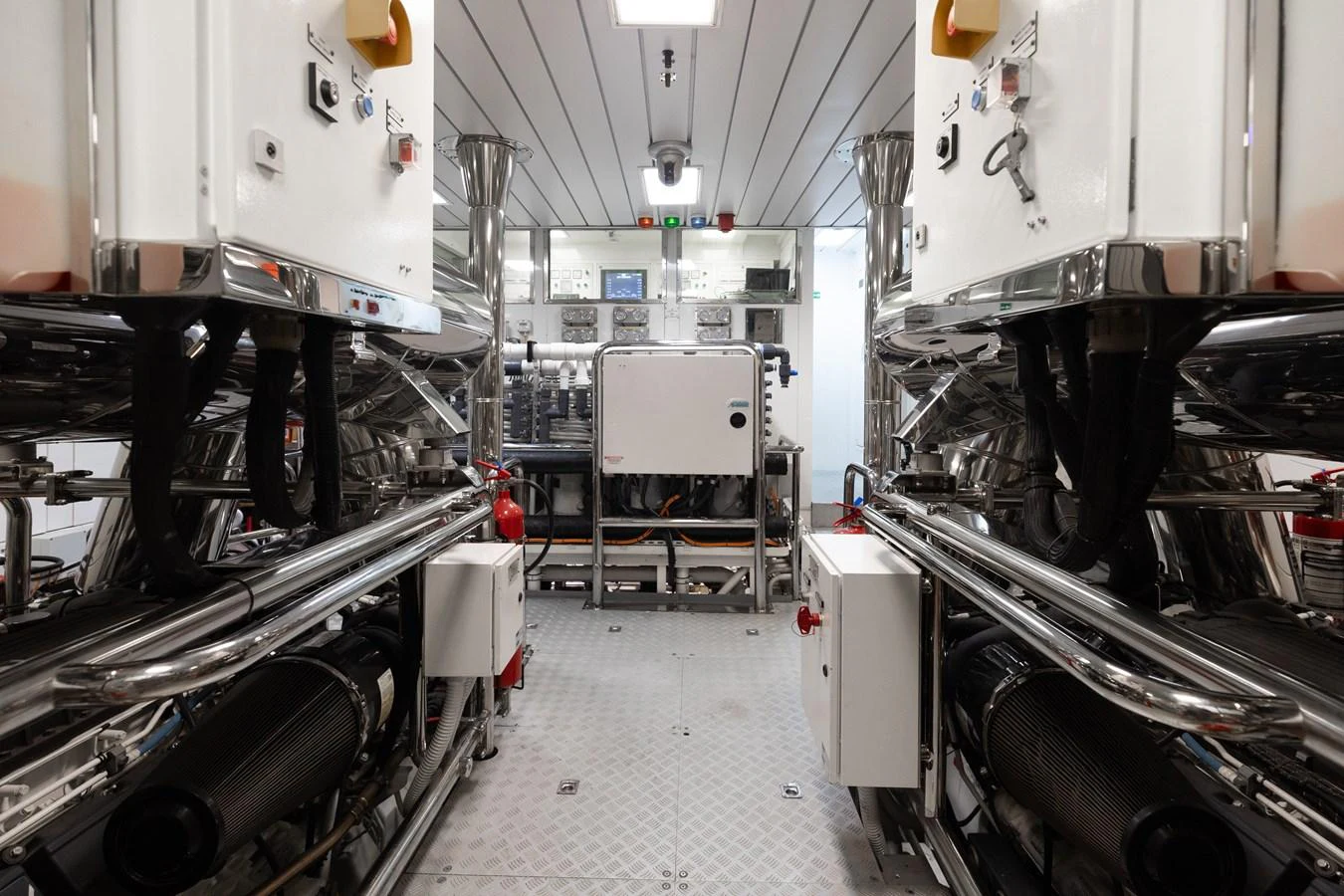 The image showcases a pristine and well-organized engine room with advanced machinery and equipment. aboard DOMANI Yacht for Sale