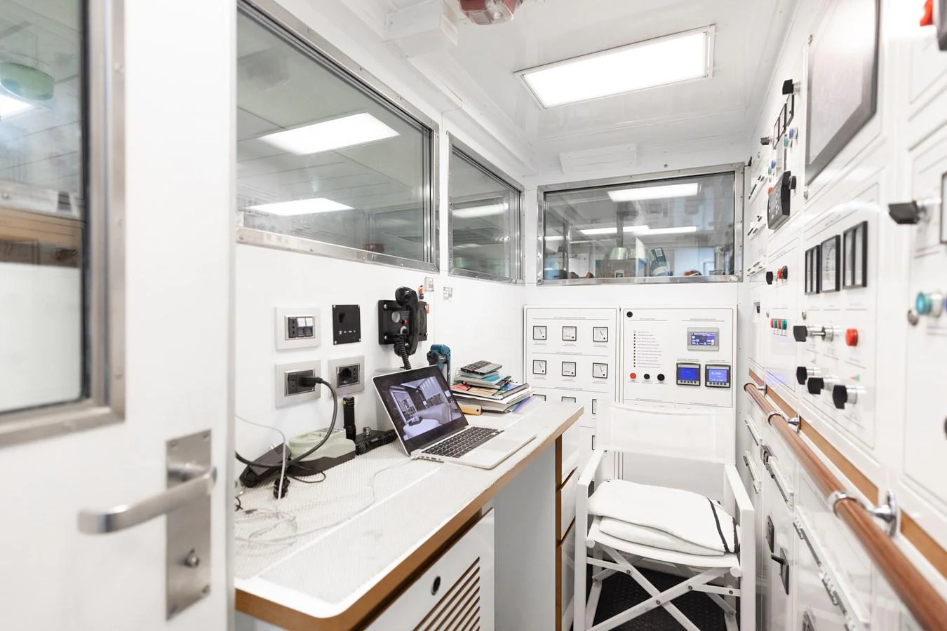The yacht's control room is equipped with advanced monitoring systems and workstations. aboard DOMANI Yacht for Sale