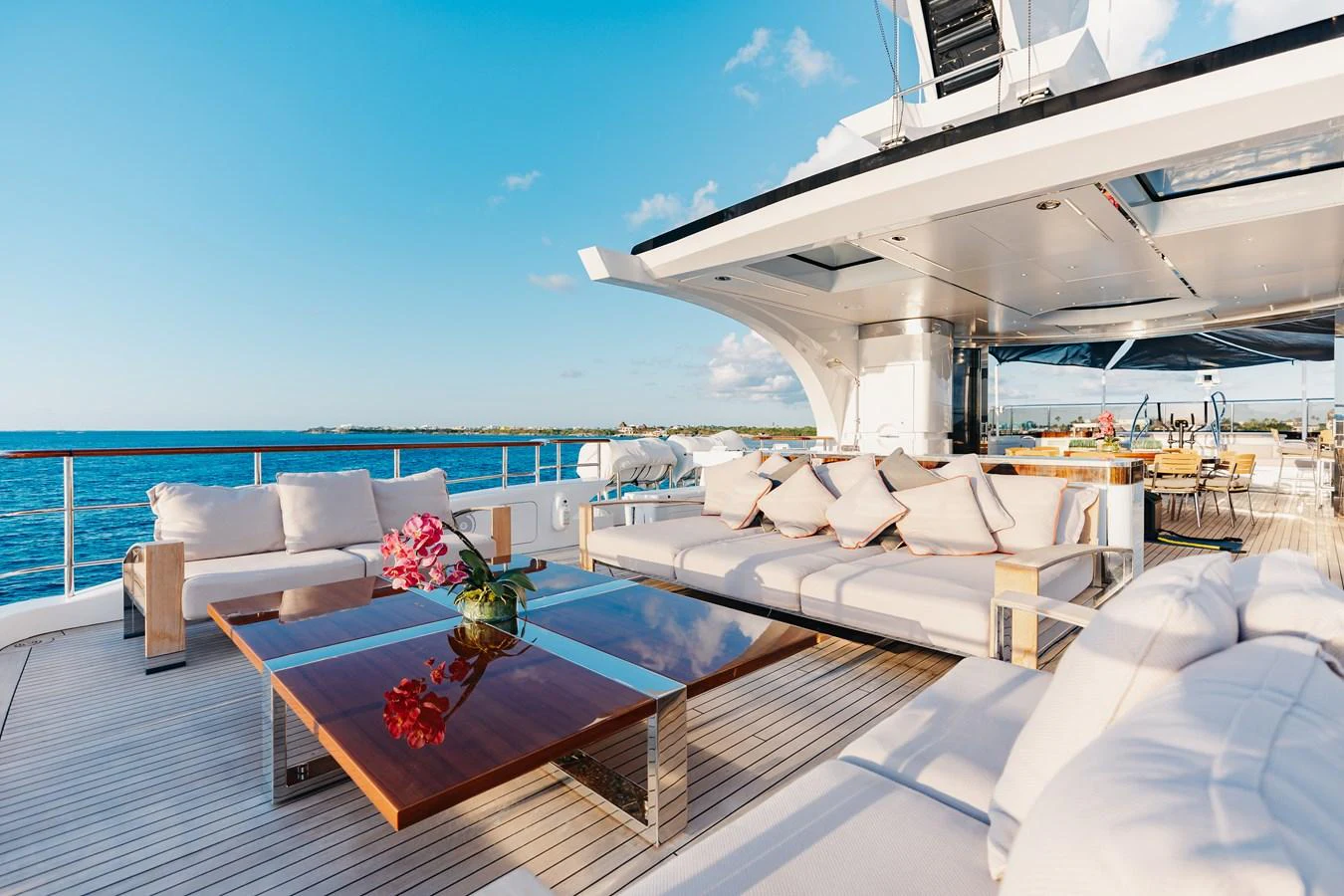 The aft deck features luxurious seating with a stunning ocean view. aboard DOMANI Yacht for Sale