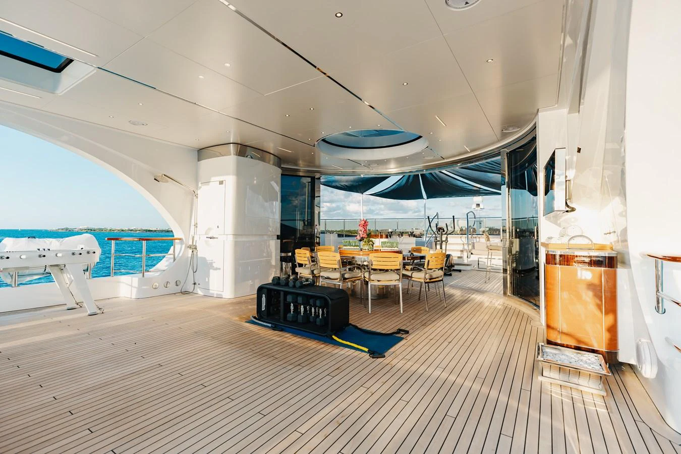 The aft deck offers a spacious and luxurious outdoor dining area with stunning views. aboard DOMANI Yacht for Sale