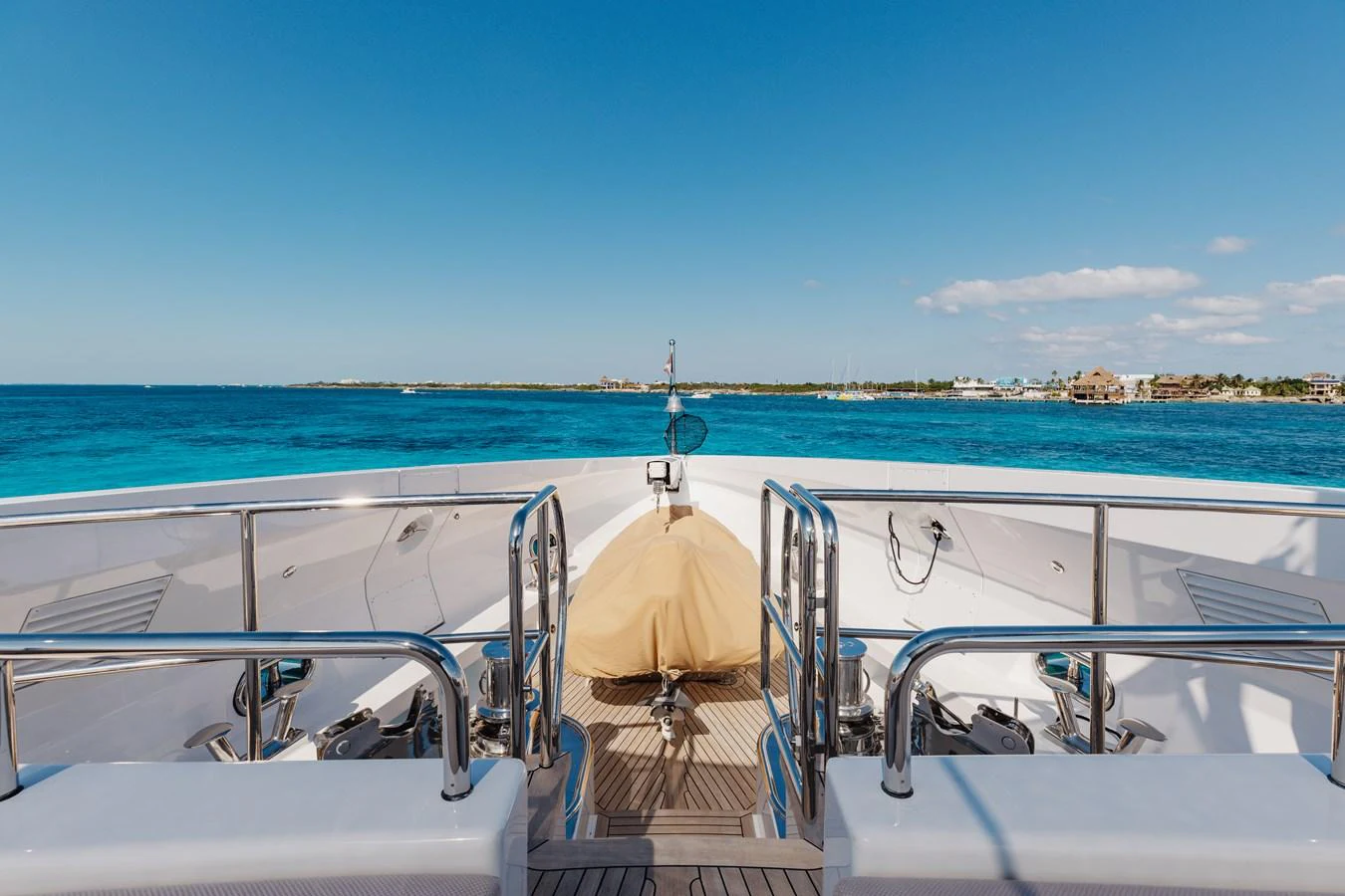 The bow of the yacht offers a stunning view of the open sea and distant shoreline. aboard DOMANI Yacht for Sale