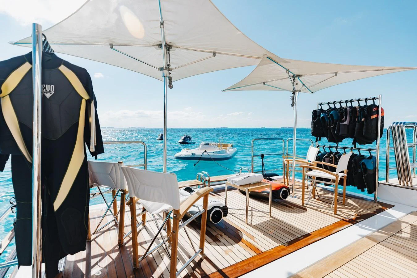 The aft deck is equipped with comfortable seating and water sports gear, perfect for enjoying a sunny day on the water. aboard DOMANI Yacht for Sale