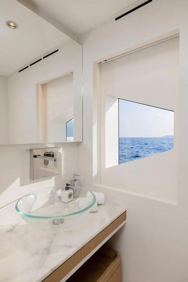a bathroom with a sink and a window aboard MAJESTY 120 Yacht for Sale