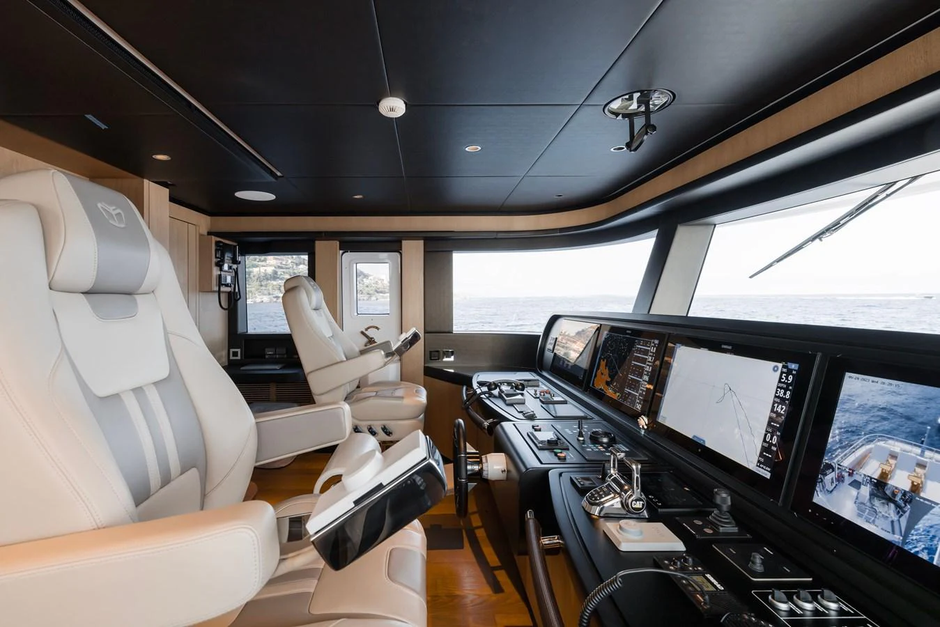 a room with many monitors and a chair aboard MAJESTY 120 Yacht for Sale