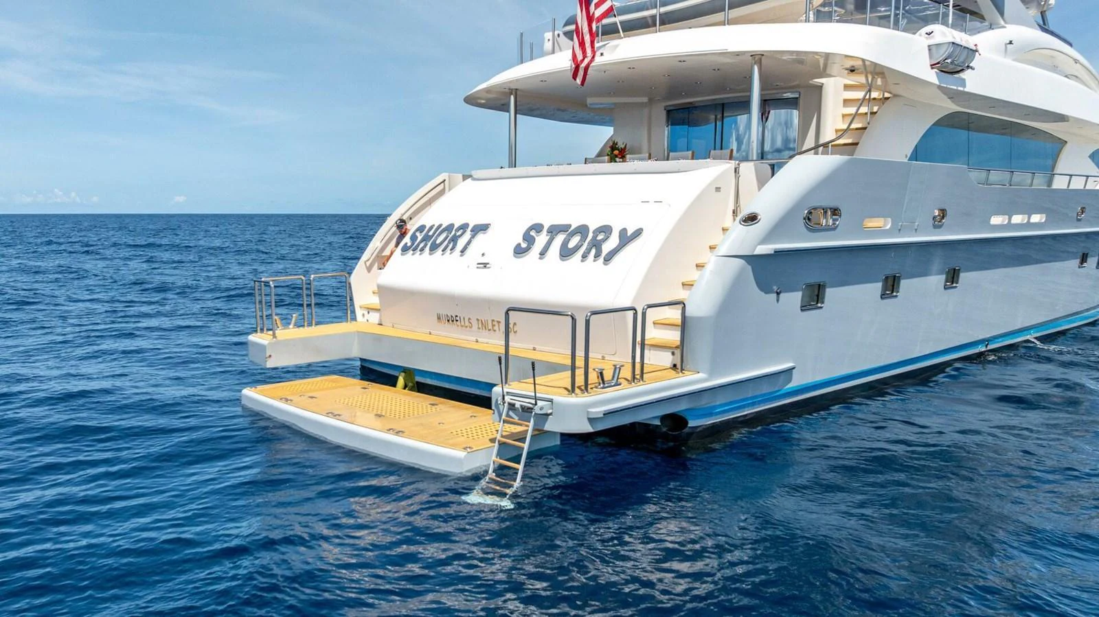 The yacht's aft deck features a spacious swim platform and elegant design, perfect for enjoying the sea. aboard SHORT STORY Yacht for Sale